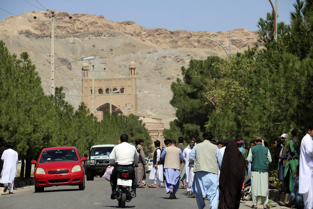 Afghan people gather near the site of an explosion in Herat province, Afghanistan, Friday, Sept 2, 2022. Taliban officials and a local medic say an explosion tore through a crowded mosque in western Afghanistan, killing more than a dozen of people, including a prominent cleric. (AP Photo/Omid Haqjoo)
