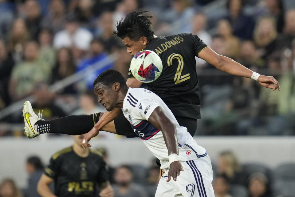 Los Angeles FC defender Denil Maldonado (2) and Vancouver Whitecaps forward Sergio Córdova (9) jump up to head the ball during the first half of an MLS soccer match in Los Angeles, Saturday, June 24, 2023. (AP Photo/Ashley Landis)