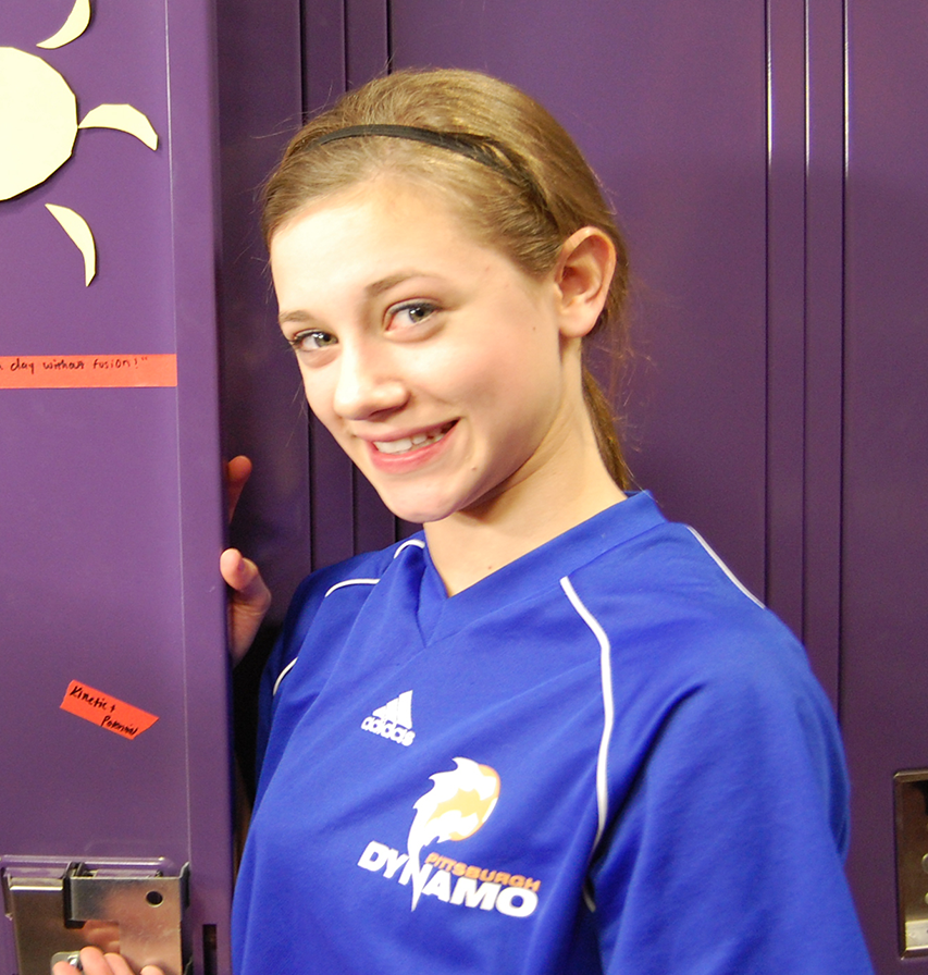 young Lili smiling in a sports jersey