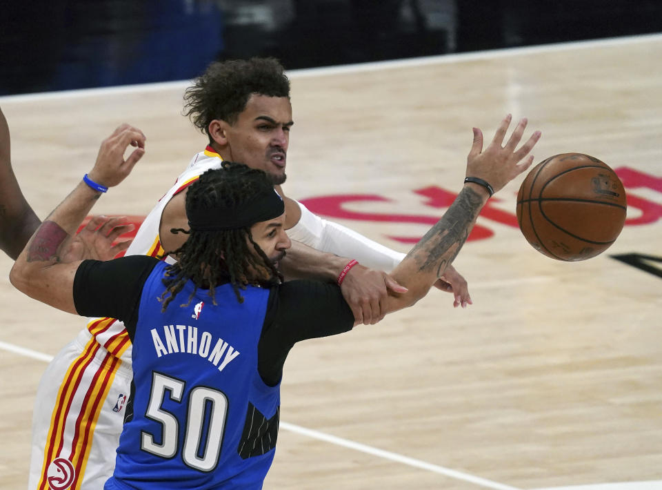 Orlando Magic guard Cole Anthony (50) knocks the ball from Atlanta Hawks guard Trae Young (11) in the second half of an NBA basketball game Thursday, May 13, 2021 in Atlanta. (AP Photo/Tami Chappel)