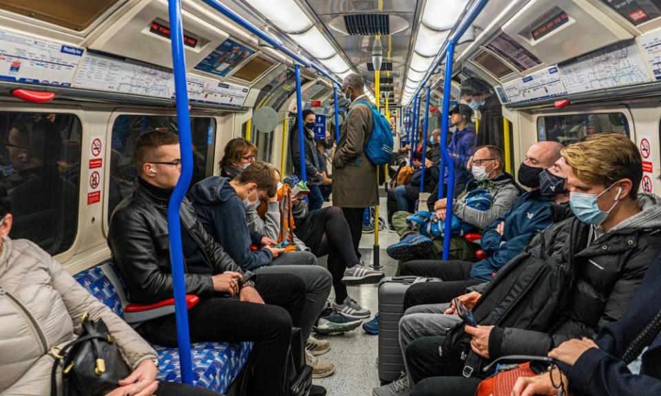 A mixture of masked and unmasked passengers on the London Underground