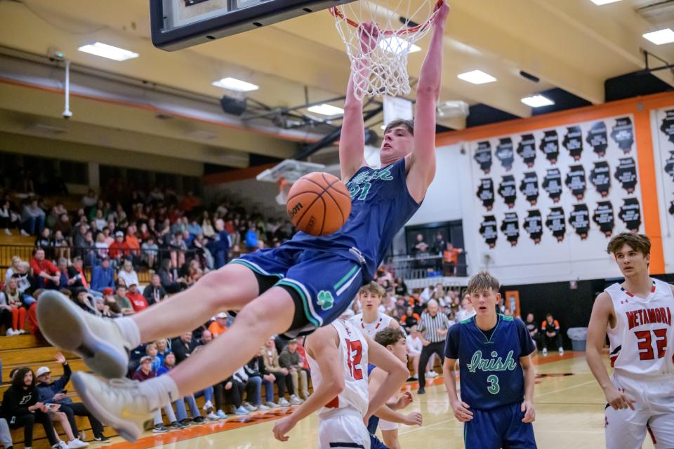 Peoria Notre Dame's Eoin Dillon slam dunks on Metamora in the second half of their Tournament of Champions basketball game Tuesday, Nov. 21 2023 in Washington. The Redbirds defeated the Irish 64-45.