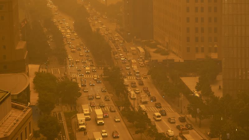 Traffic moves along Wednesday, June 7, 2023, in New York, amidst smokey haze from wildfires in Canada. Smoke from Canadian wildfires poured into the U.S. East Coast and Midwest on Wednesday, covering the capitals of both nations in an unhealthy haze, holding up flights at major airports and prompting people to fish out pandemic-era face masks.