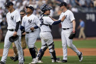 New York Yankees starting pitcher Gerrit Cole, right, celebrates with his teammates after closing the ninth inning of a baseball game against the Minnesota Twins to record a complete game shutout, Sunday, April 16, 2023, in New York. (AP Photo/John Minchillo)