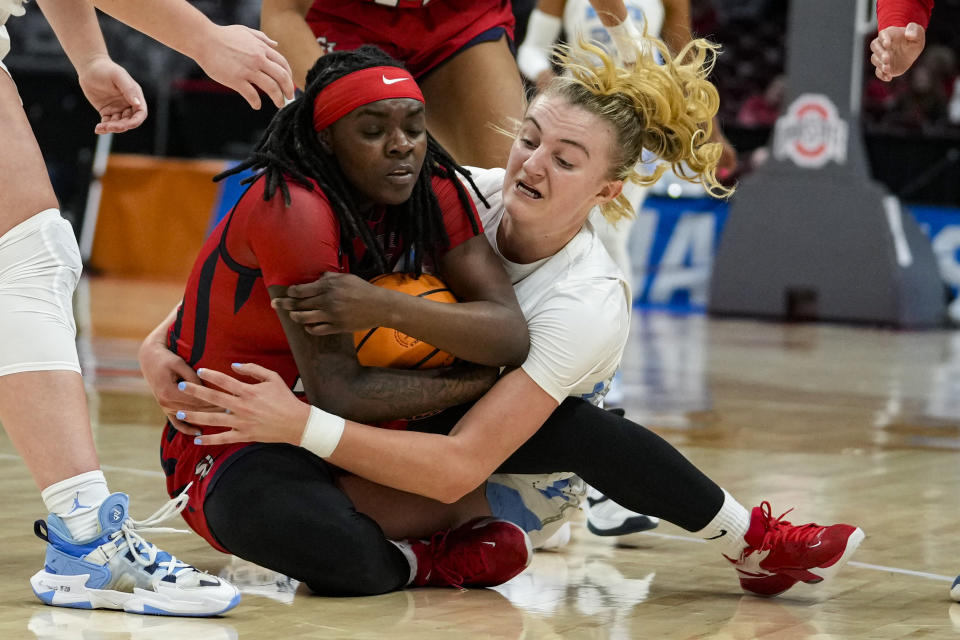 St. John's guard Unique Drake,Left, and North Carolina guard Alyssa Ustby (1) go to the floor for a loose ball in the first half of a second-round college basketball game in the women's NCAA Tournament in Columbus, Ohio, Saturday, March 18, 2023. (AP Photo/Michael Conroy)