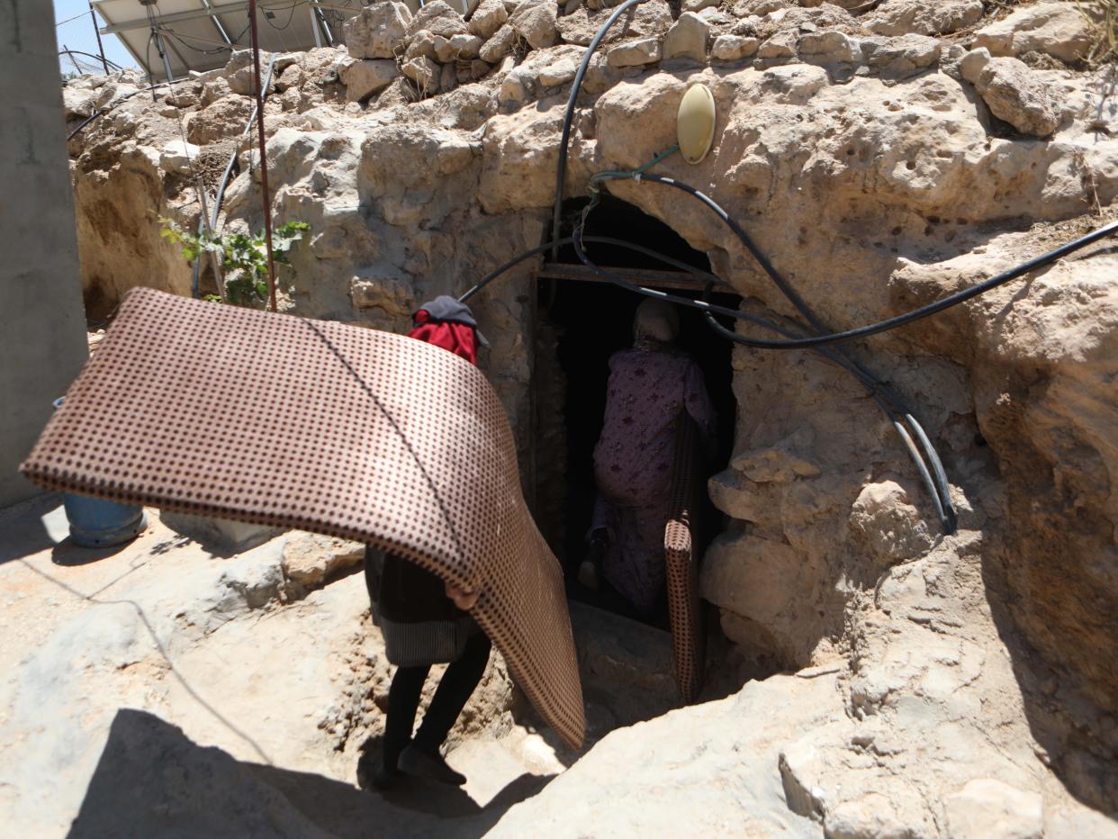 HEBRON, WEST BANK - MAY 7: Members of Palestinian Masafer Yatta communities living in caves and makeshift buildings determined to remain in their land despite the Israeli court's decision allowing the forced eviction, south of Hebron in West Bank on May 7, 2022. On May 5, Israeli Supreme Court ended a legal dispute between the Israeli state, which designated the territory in the South Hebron Hills a firing zone in 1981, and the Palestinians who lived there for decades. The decision practically approves the eviction of 1,200 Palestinians from eight villages in the region. (Photo by Mamoun Wazwaz/Anadolu Agency via Getty Images)