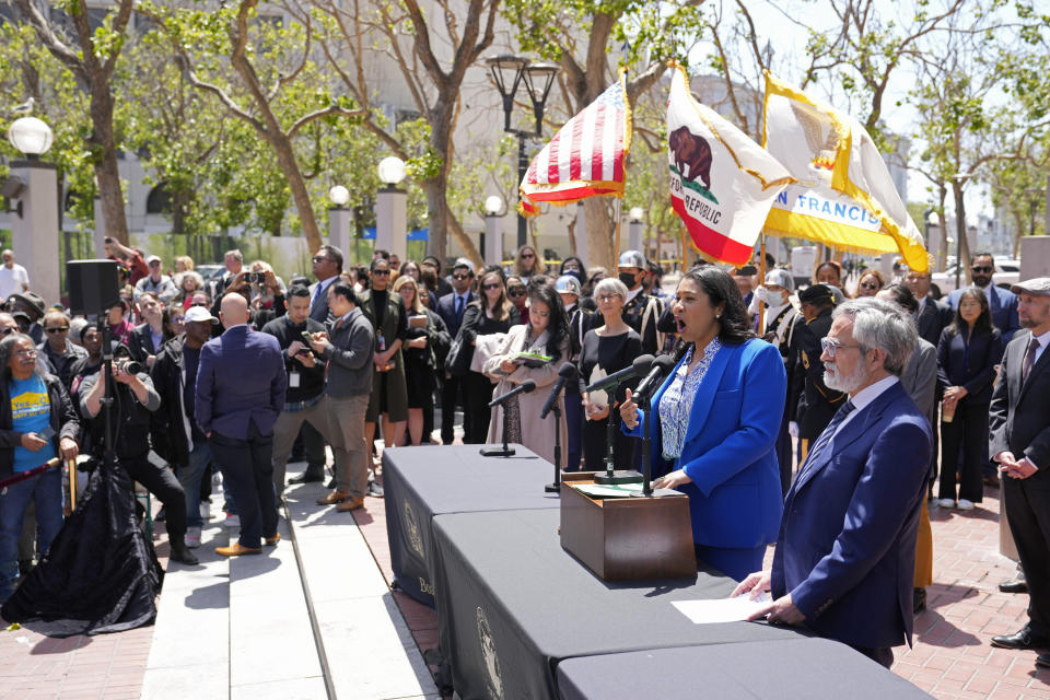 San Francisco Mayor London Breed speaks during a rare outdoor meeting of the Board of Supervisors at UN Plaza in San Francisco, Tuesday, May 23, 2023. Mayor Breed attempted to answer questions from supervisors demanding her administration do more to shut down open-air drug dealing, but the meeting had to be moved indoors to City Hall because of disruptions. Listening at right is Board of Supervisors President Aaron Peskin. (AP Photo/Eric Risberg)