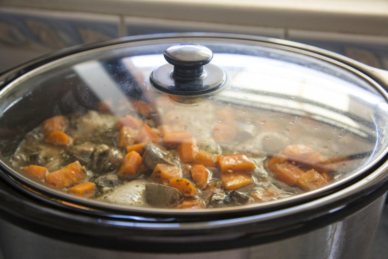 Chicken, carrots and mushrooms cooking in a slow cooker. Chicken Chasseur.