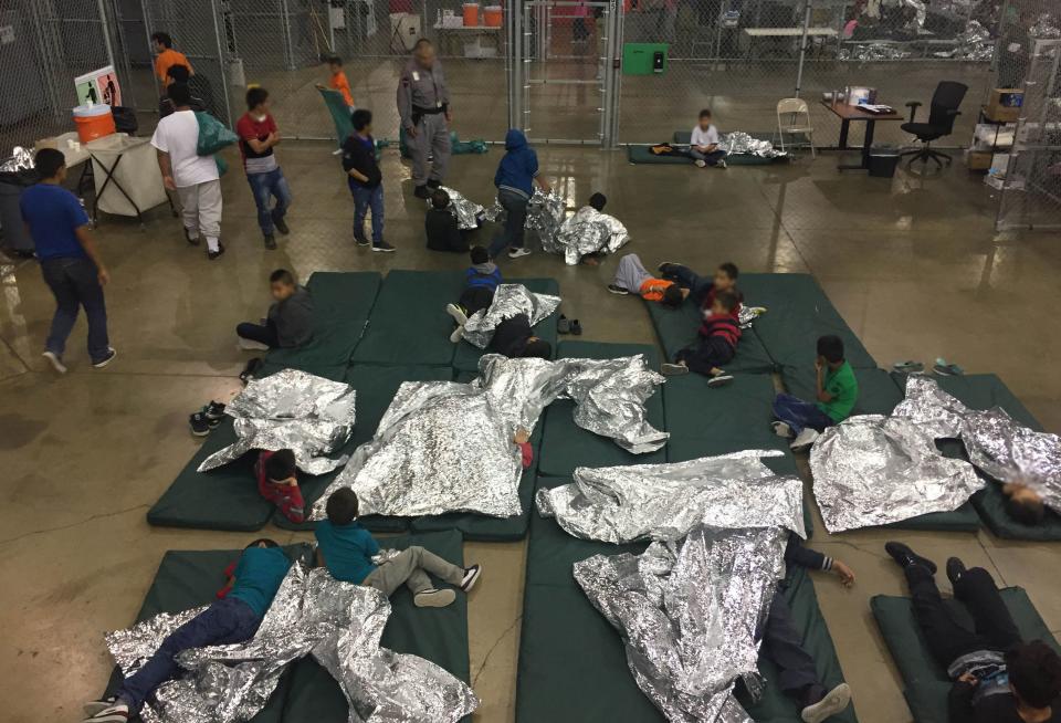 Children lie on sleeping pads with space blankets at the Rio Grande Valley Centralized Processing Center in Rio Grande City, Texas. (Photo: CBP/Handout via Reuters)