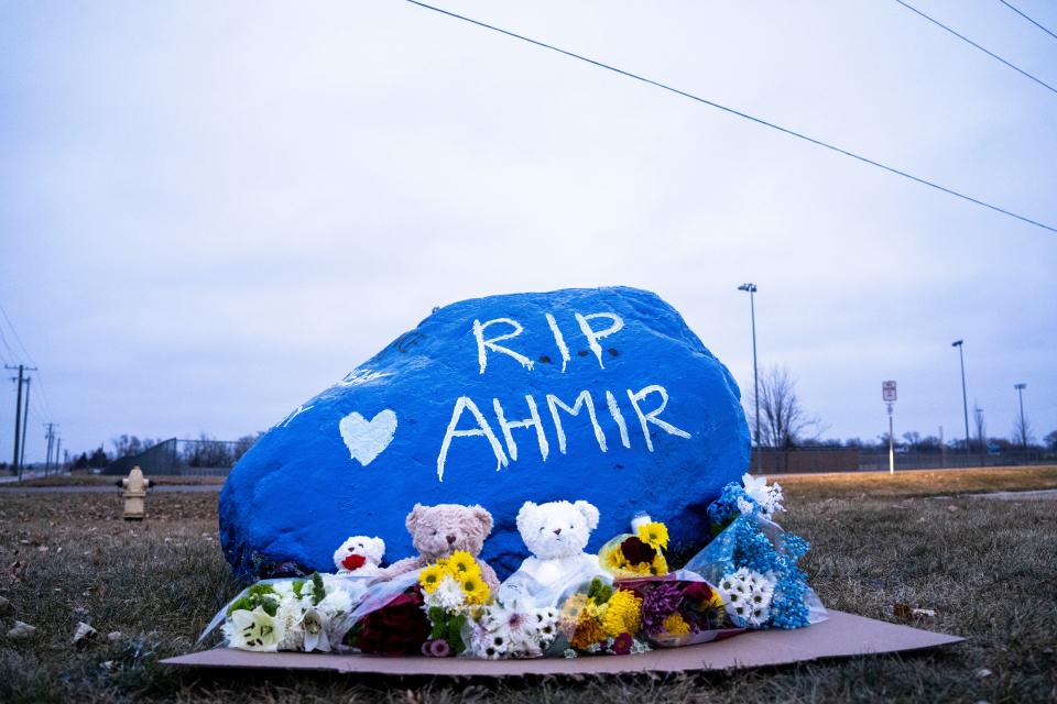 A rock is painted to memorialize Perry High School shooting victim Ahmir Jolliff at the school.