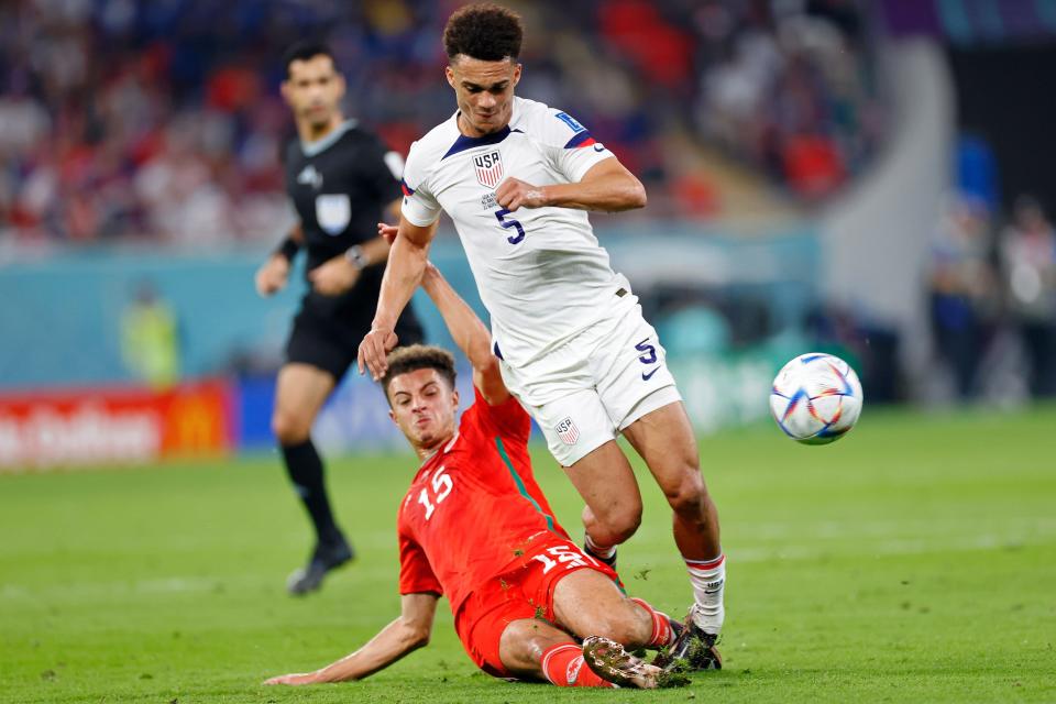 Wales defender Ethan Ampadu slides tackles US defender Antonee Robinson during the first half of Monday's game.