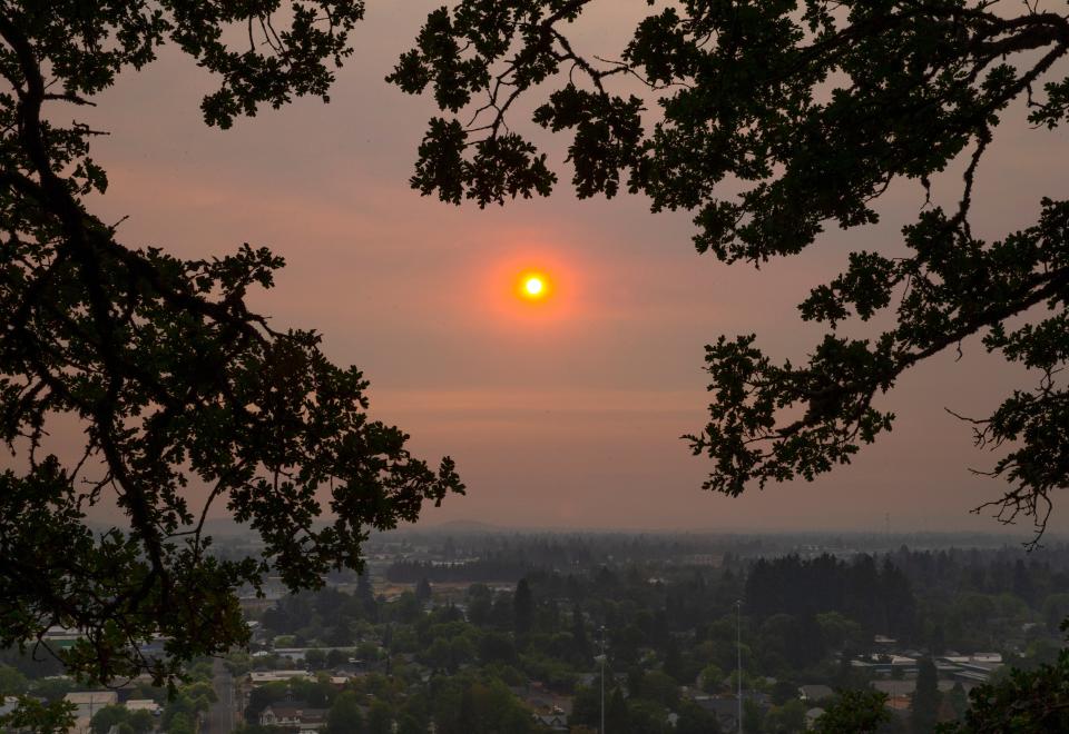 The Sun shines through a thick layer of smoke from nearby wildfires from Skinner Butte in Eugene Monday night.