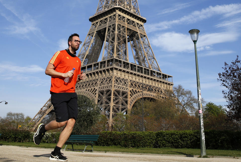 PARIS, FRANCE - APRIL 07: A jogger runs in front of the Eiffel Tower as lockdown continues due to the coronavirus (COVID 19) outbreak on April 7, 2020, in Paris, France. The Paris city hall and the police prefecture have banned jogging in Paris between 10 a.m. and 7 p.m. to stem the Covid-19 epidemic. The country is issuing fines for people caught violating its nationwide lockdown measures intended to stop the spread of COVID-19. The Coronavirus (COVID-19) pandemic has spread to many countries across the world, claiming over 79,000 lives and infecting over 1 million people. (Photo by Chesnot/Getty Images)