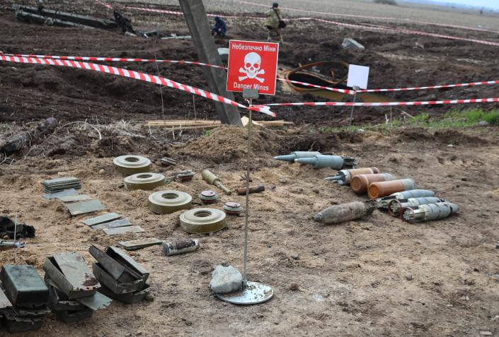 unexploded munitions and other explosive devices as members of a demining team of the State Emergency Service of Ukraine clear mines off a field not far from the town of Brovary, northeast of Kyiv, on April 21, 2022, amid Russian invasion of Ukraine.