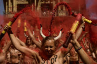 <p>Demonstrators break <em>banderillas</em> with red dust during a protest against bullfighting in front of city hall on July 5, a day before the San Fermín festival in Pamplona. (Photo: Alvaro Barrientos/AP) </p>