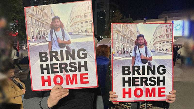 Protesters in Israel hold a poster of a young hostage with text that reads, "Bring Hersh Home."