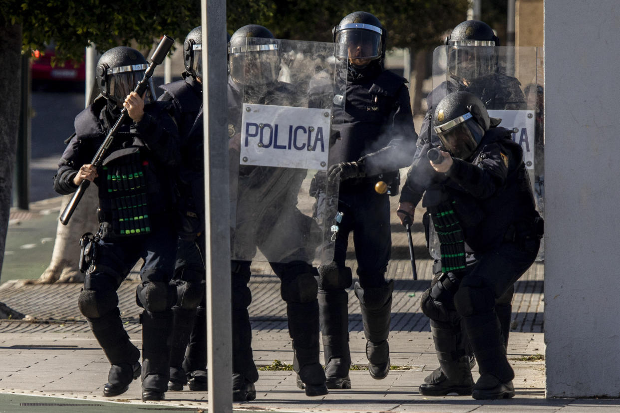 Anti-riot police fires a rubber projectile towards protesters during a strike organized by metal workers in Cadiz, southern Spain, Tuesday, Nov. 23, 2021. (AP Photo/Javier Fergo)