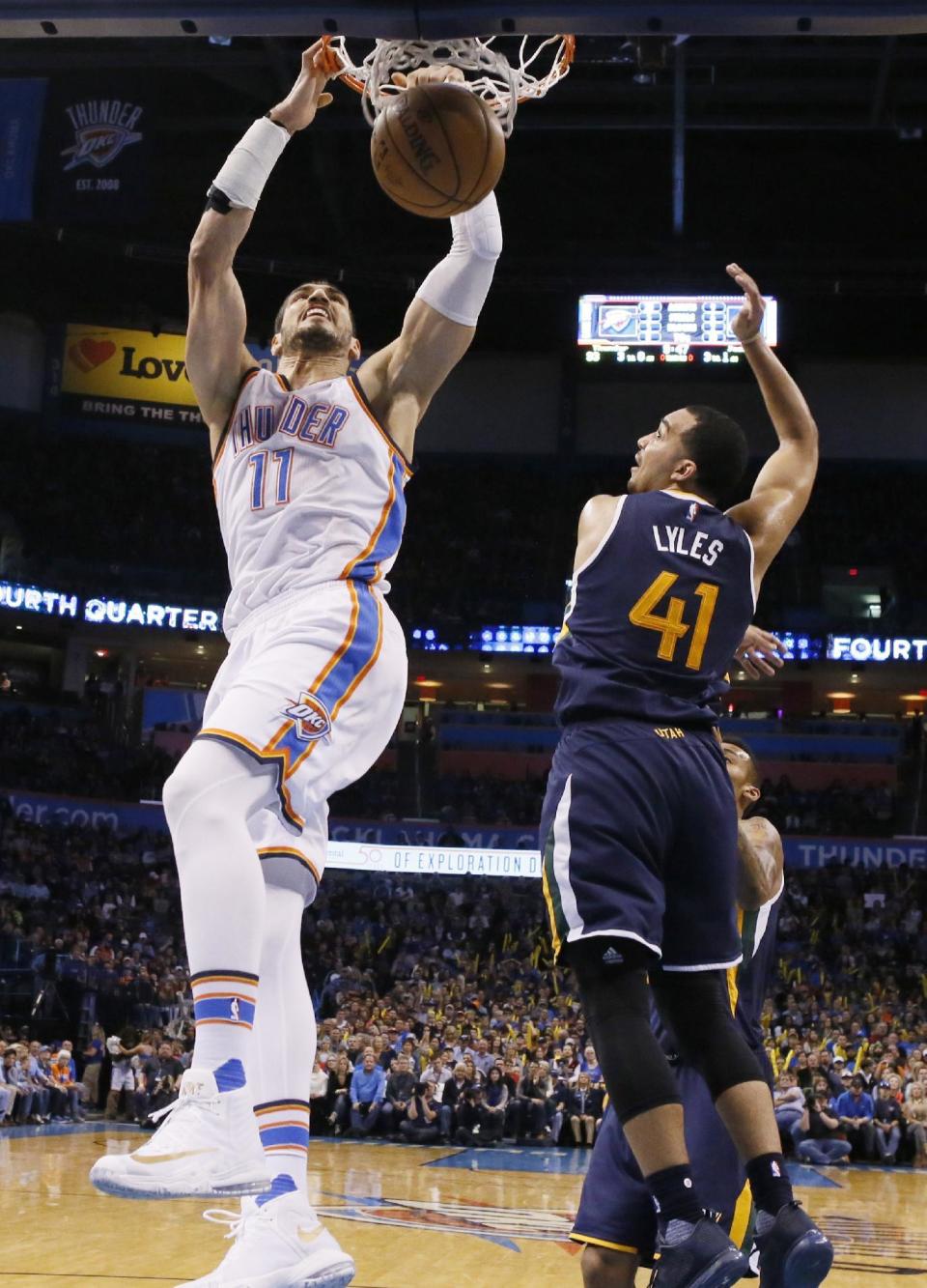 Oklahoma City Thunder center Enes Kanter (11) dunks in front of Utah Jazz forward Trey Lyles (41) in the fourth quarter of an NBA basketball game in Oklahoma City, Saturday, March 11, 2017. Oklahoma City won 112-104. (AP Photo/Sue Ogrocki)