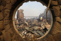 <p>The fire-ravaged Signorello Estate Winery is seen through a window Monday, Oct. 9, 2017, in Napa, Calif. Wildfires whipped by powerful winds swept through Northern California sending residents on a headlong flight to safety through smoke and flames as homes burned. (Photo: Marcio Jose Sanchez/AP) </p>