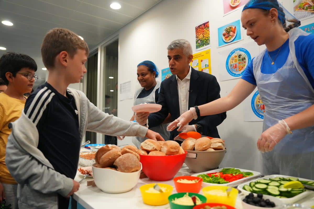 Food smiles: Sadiq Khan helps serve school lunches (Getty Images)