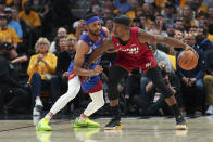 Miami Heat forward Jimmy Butler, right, is defended by Denver Nuggets forward Bruce Brown during the first half of Game 1 of basketball's NBA Finals, Thursday, June 1, 2023, in Denver. (AP Photo/Jack Dempsey)