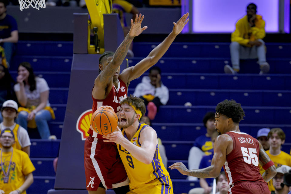 LSU forward Will Baker (9) tries to shoot around Alabama forward Nick Pringle (23) during the first half of an NCAA college basketball game in Baton Rouge, La., Saturday, Feb. 10, 2024. (AP Photo/Matthew Hinton)