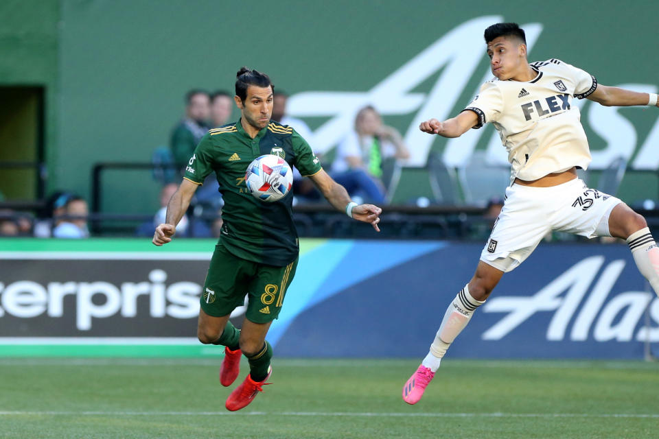 Portland Timbers midfielder Diego Valeri controls a pass off his chest next to Los Angeles FC's Marco Farfanduring an MLS soccer match Wednesday, July 21, 2021, in Portland, Ore. (Sean Meagher/The Oregonian via AP)