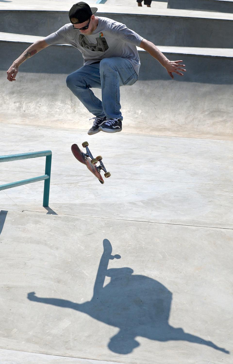 Larry Manke flips his board as he tries out the new Belmont Skateboard Park on East Catawba Street during the skate park expo held Saturday, June 25, 2022.