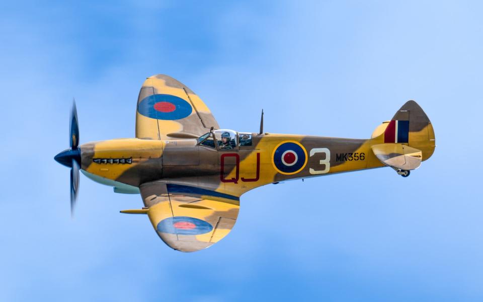 The yellow-and-brown plane is seen against a blue sky