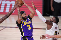 Los Angeles Lakers' Anthony Davis (3) moves the ball against Denver Nuggets' Paul Millsap (4) during the second half of an NBA conference final playoff basketball game Saturday, Sept. 26, 2020, in Lake Buena Vista, Fla. (AP Photo/Mark J. Terrill)