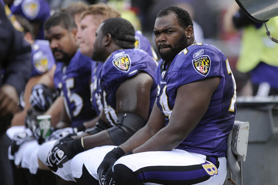 FILE - Baltimore Ravens offensive tackle Michael Oher sits on the beach during the first half of an NFL football game against the Buffalo Bills in Baltimore, Sunday, Oct. 24, 2010. Michael Oher, the former NFL tackle known for the movie “The Blind Side,” filed a petition Monday in a Tennessee probate court accusing Sean and Leigh Anne Tuohy of lying to him by having him sign papers making them his conservators rather than his adoptive parents nearly two decades ago.(AP Photo/Nick Wass, File)