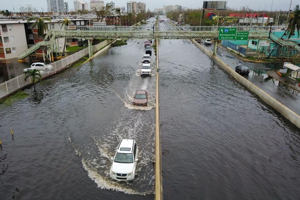 Drivers negotiate a flooded road in the aftermath of Hurricane Maria in San Juan, Sept. 21, 2017. (Photo: Ricardo Arduengo/AFP/Getty Images)