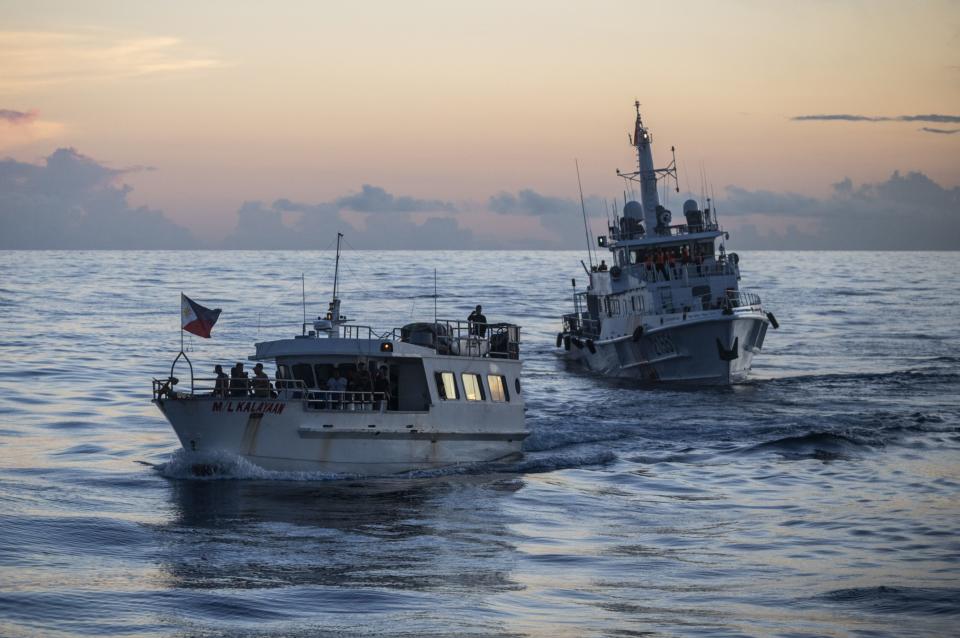 The ML Kalayaan sails past a Chinese coast guard vessel. (Photo: Lisa Marie David/Bloomberg)