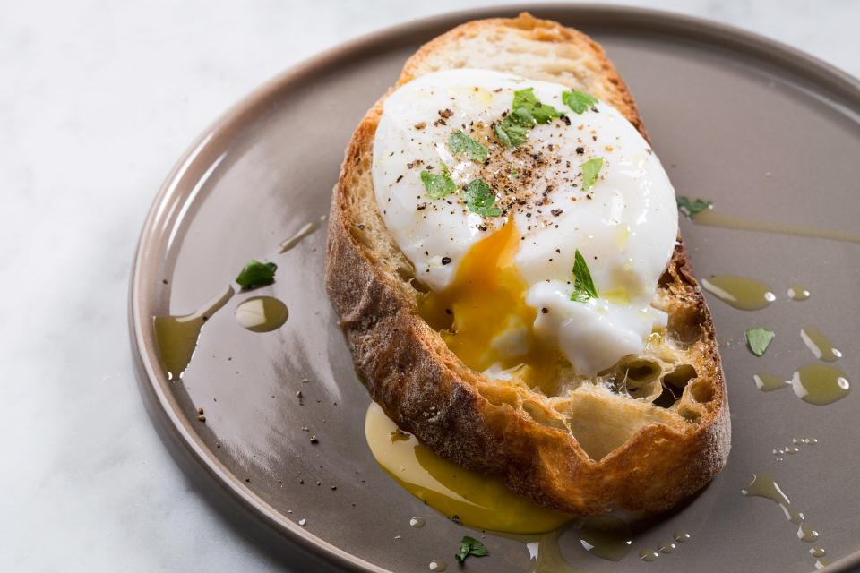 Serve the poached egg in a stewed tomato sauce, on toast with hollandaise sauce, or simply topped with salt, pepper, oil, and herbs.