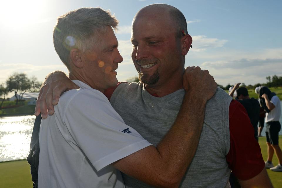 Jun 2, 2021; Scottsdale, Arizona, USA; Pepperdine University head coach Michael Beard is congratulated by Oklahoma University head coach Ryan Hybl after winning the Men's Golf Championship Final at Grayhawk Golf course. Mandatory Credit: Joe Camporeale-USA TODAY Sports