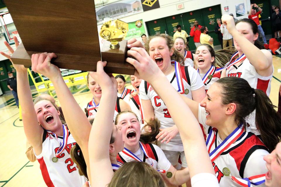 The CVU Redhawks celebrate with the trophy after defeating St Johnsbury 43-29 in the D1 State Championship game on Friday night at UVM's Patrick Gym.