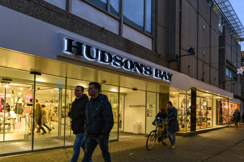 Hudson's Bay Company retail store in Zwolle during a cold winter evening. People are walking on the street and looking at the shop windows.