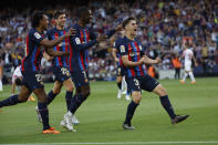 Barcelona's Gavi, right, celebrates after scoring his side's third goal during a Spanish La Liga soccer match between Barcelona and Mallorca at the Camp Nou stadium in Barcelona, Spain, Sunday, May 28, 2023. (AP Photo/Joan Monfort)