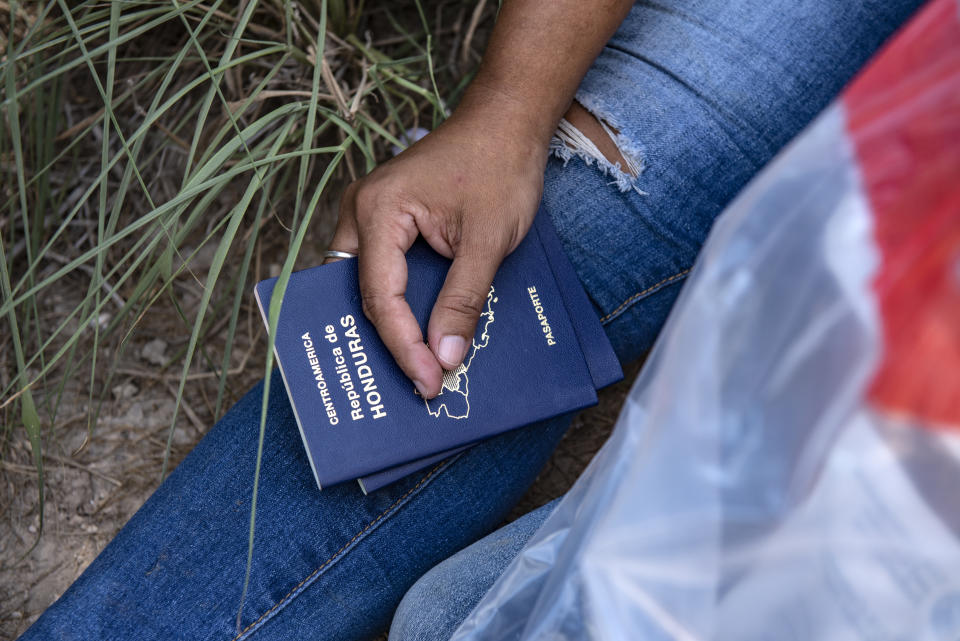 An illegal immigrant holds the passports for her and her daughter 