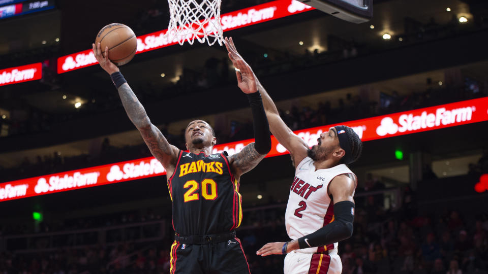 Atlanta Hawks forward John Collins (20) shoots over Miami Heat guard Gabe Vincent (2) during the first half of an NBA basketball game Friday, Jan. 21, 2022, in Atlanta. (AP Photo/Hakim Wright Sr.)