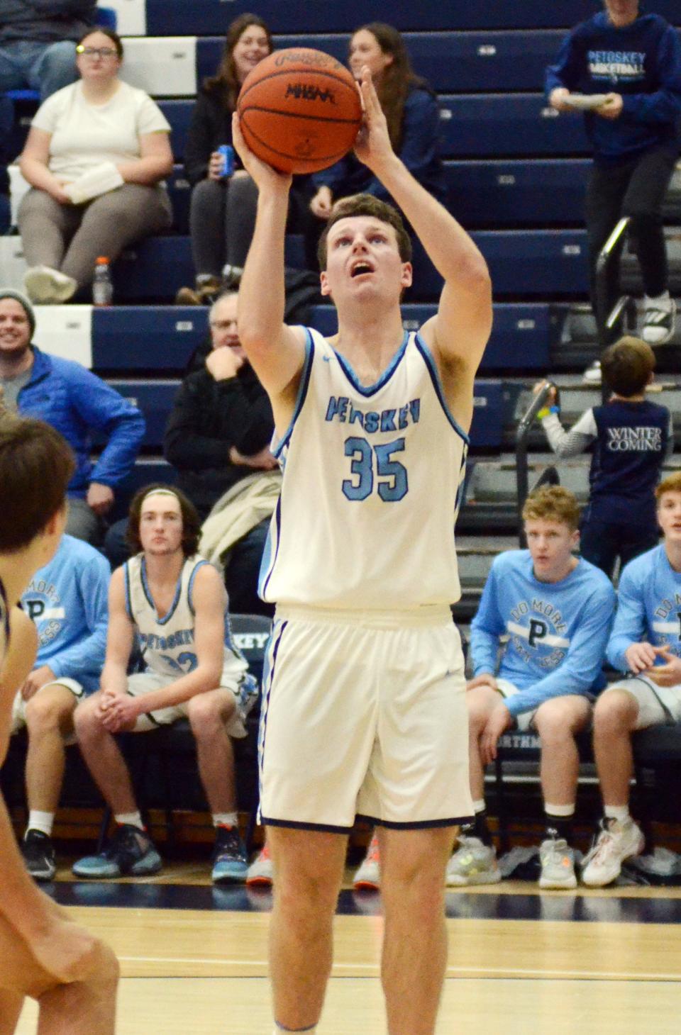 Petoskey's Jackson Jonker gets a layup under the basket in the second half.