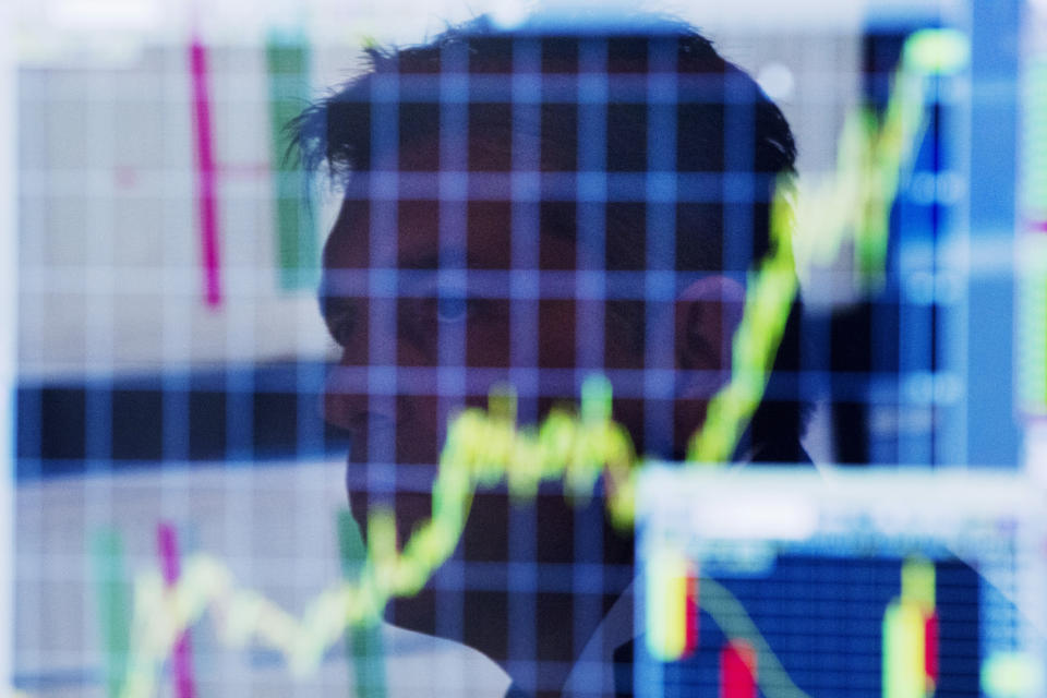 A trader looks up at a chart on his computer screen while working on the floor of the New York Stock Exchange shortly after the market opening in New York July 11, 2013. Global stock indexes rose sharply while the dollar tumbled on Thursday after Federal Reserve chief Ben Bernanke signaled the U.S. central bank may not be as close to winding down its stimulus policy as markets had begun to expect. REUTERS/Lucas Jackson (UNITED STATES - Tags: BUSINESS)