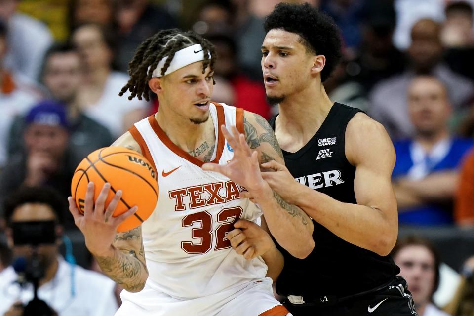 Texas Longhorns forward Christian Bishop (32) compete for position against Xavier Musketeers forward Cesare Edwards (4) during the first half of a Sweet 16 college basketball game between the Xavier Musketeers and the Texas Longhorns in the Midwest Regional of the NCAA Tournament, Friday, March 24, 2023, at T-Mobile Center in Kansas City, Mo.