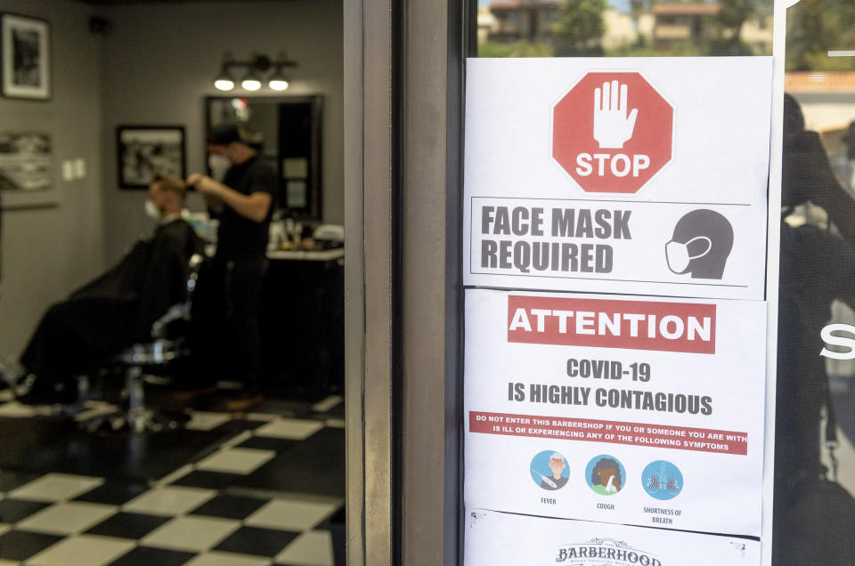 LAGUNA HILLS, CA - MAY 05: Customers maintain safety protocols at The BarberHood in Laguna Hills, CA, on Tuesday, May 5, 2020. The shop is one of the first to re-open and defy the state"u2019s stay-at-home order during the COVID-19 (coronavirus) lockdown. (Photo by Paul Bersebach/MediaNews Group/Orange County Register via Getty Images)