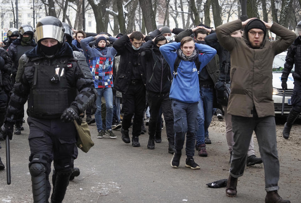 Detained protesters walk escorted by police during a protest against the jailing of opposition leader Alexei Navalny in St. Petersburg, Russia, Sunday, Jan. 31, 2021. Thousands of people took to the streets Sunday across Russia to demand the release of jailed opposition leader Alexei Navalny, keeping up the wave of nationwide protests that have rattled the Kremlin. Hundreds were detained by police. (AP Photo/Dmitri Lovetsky)