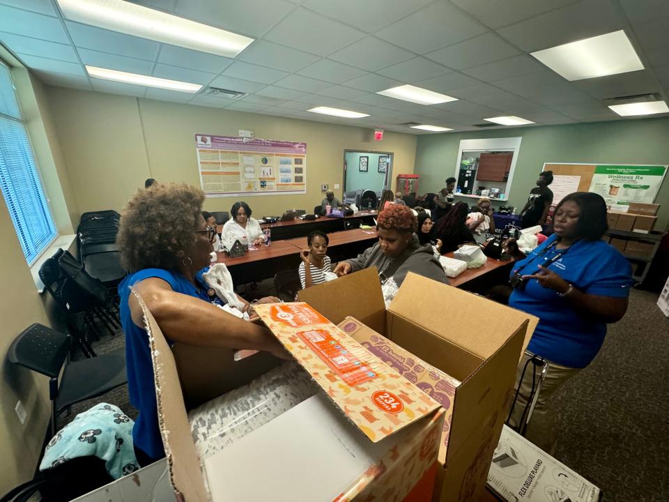 Willie Roberts, Ascension St. Vincent’s Community Outreach-Faith Community Nursing manager, left, and registered nurse Donna Watts prepare to hand out diapers at the Brighter Beginnings class for pregnant women and new mothers.