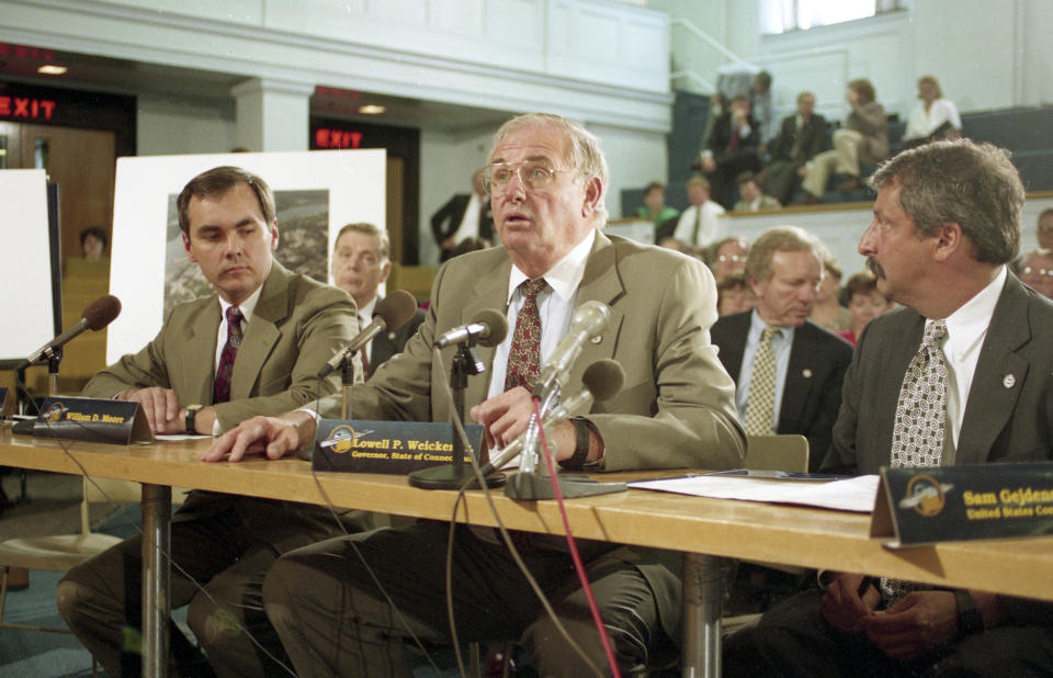 Connecticut Gov. Lowell Weicker, center, addresses the Defense Base Closure and Realignment Committee on May 11, 1993, at the Massachusetts Statehouse in Boston. Weicker is flanked by William D. Moore, left, and U.S. Rep. Sam Gejdenson, D-Conn. Weicker, a Republican U.S. senator who tussled with his own party during the Watergate hearings, championed legislation to protect people with disabilities and later was elected Connecticut governor as an independent, died Wednesday, June 28, 2023, at a hospital in Middletown, Conn., after a short illness. He was 92. (AP Photo/Charles Krupa)