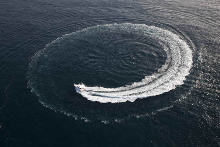 A boat at sea turning around in a tight circle.