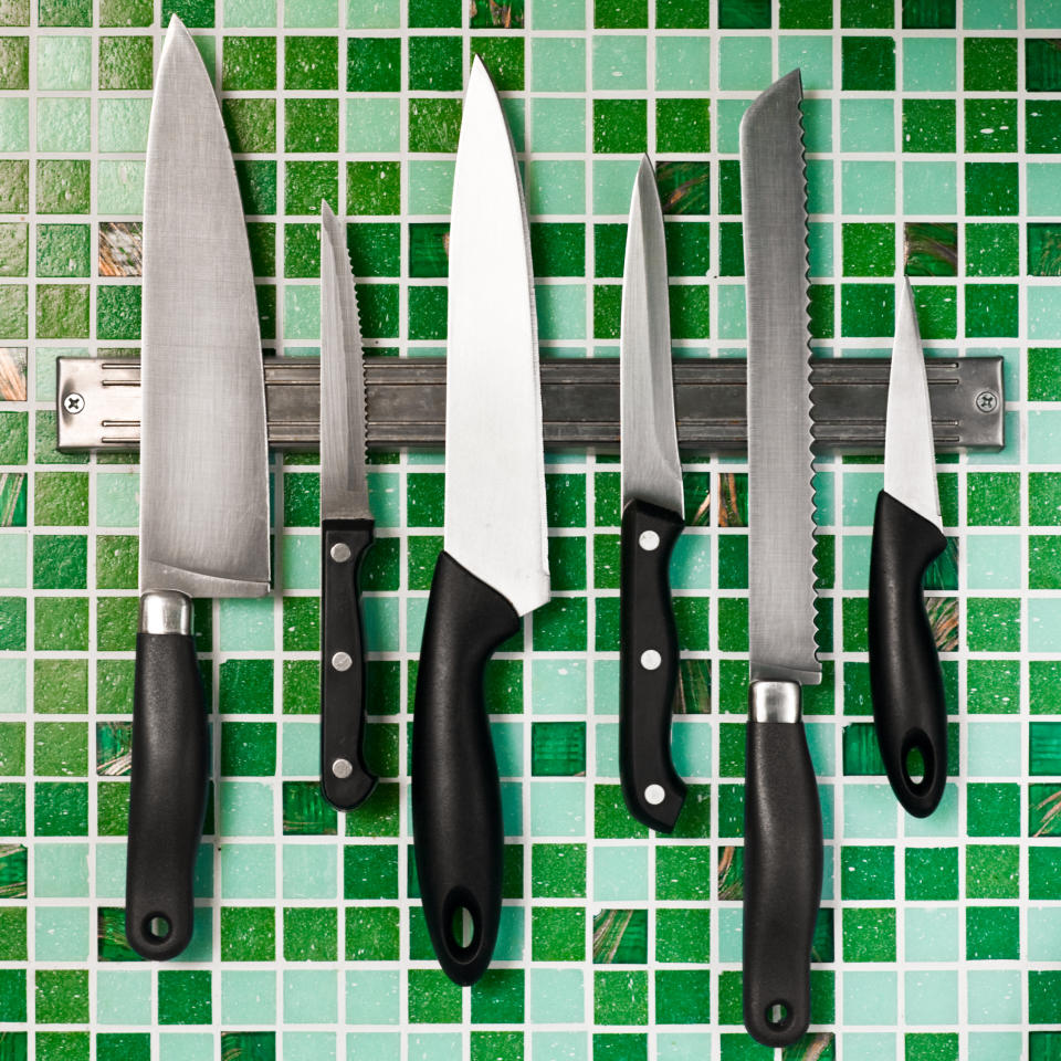 A set of knives mounted on tile