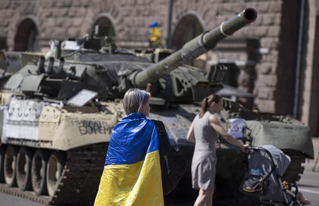 A Ukrainian woman is seen with a Ukraine flag in front of the tank, captured by Ukrainian forces during the war against Russia, during Ukraine's 31st Independence Day in Kyiv, Ukraine on August 24. (Photo: Anadolu Agency via Getty Images)